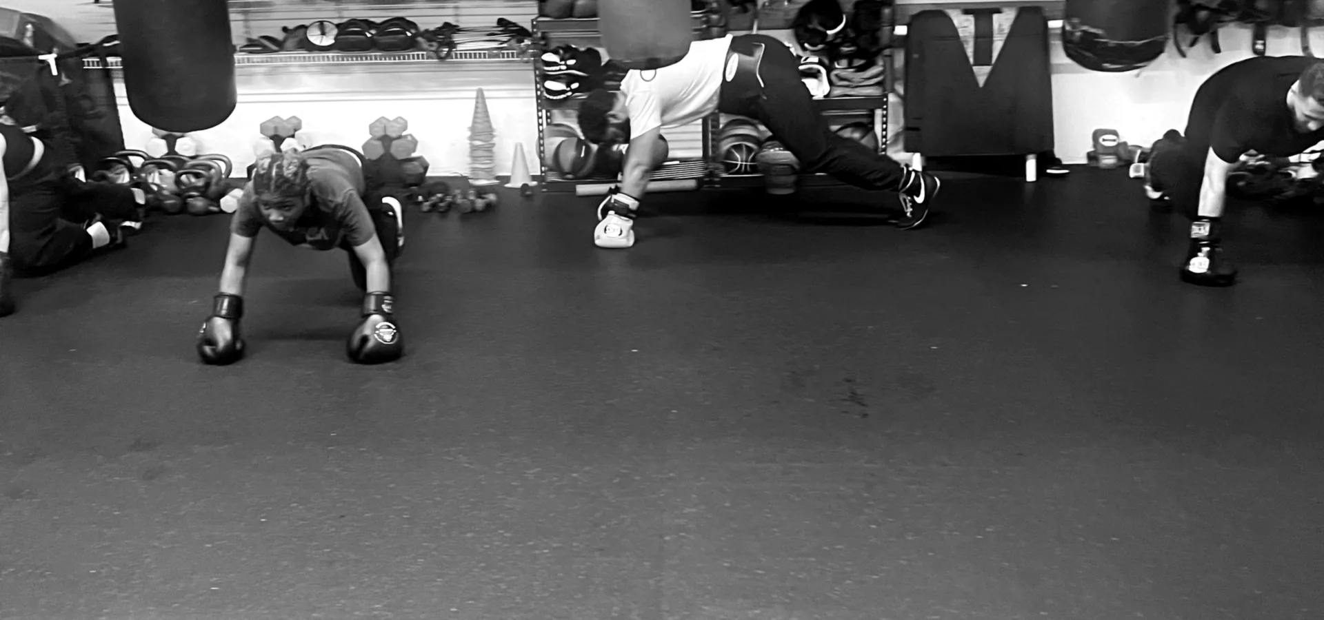 K.O. Fitness athletes holding a plank during conditioning rounds in Seattle