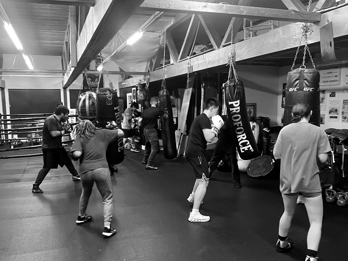 Boxing class working the heavy bags during a group session at K.O. Fitness in Seattle